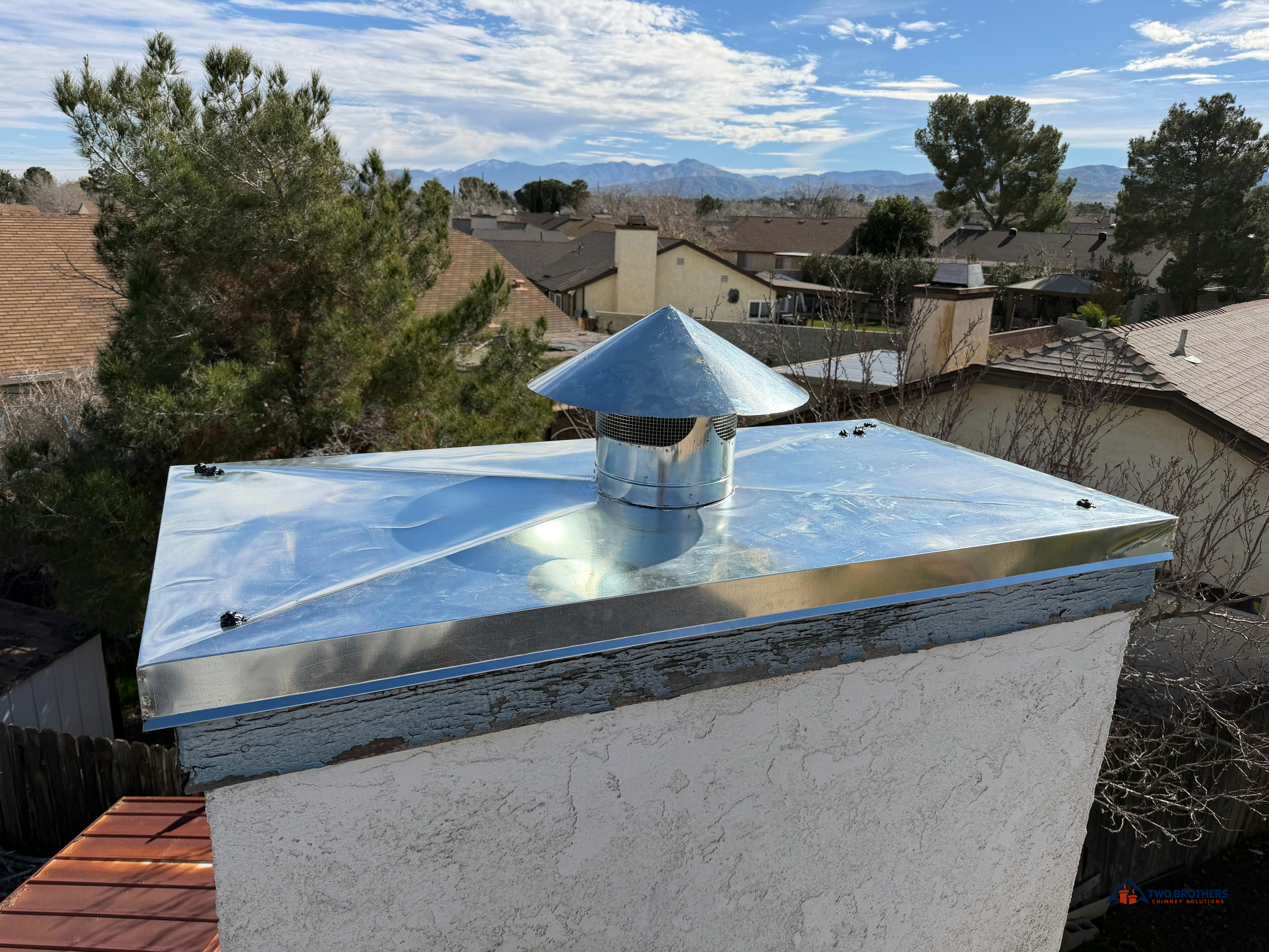 Angled view of a metal chase cover and round cap